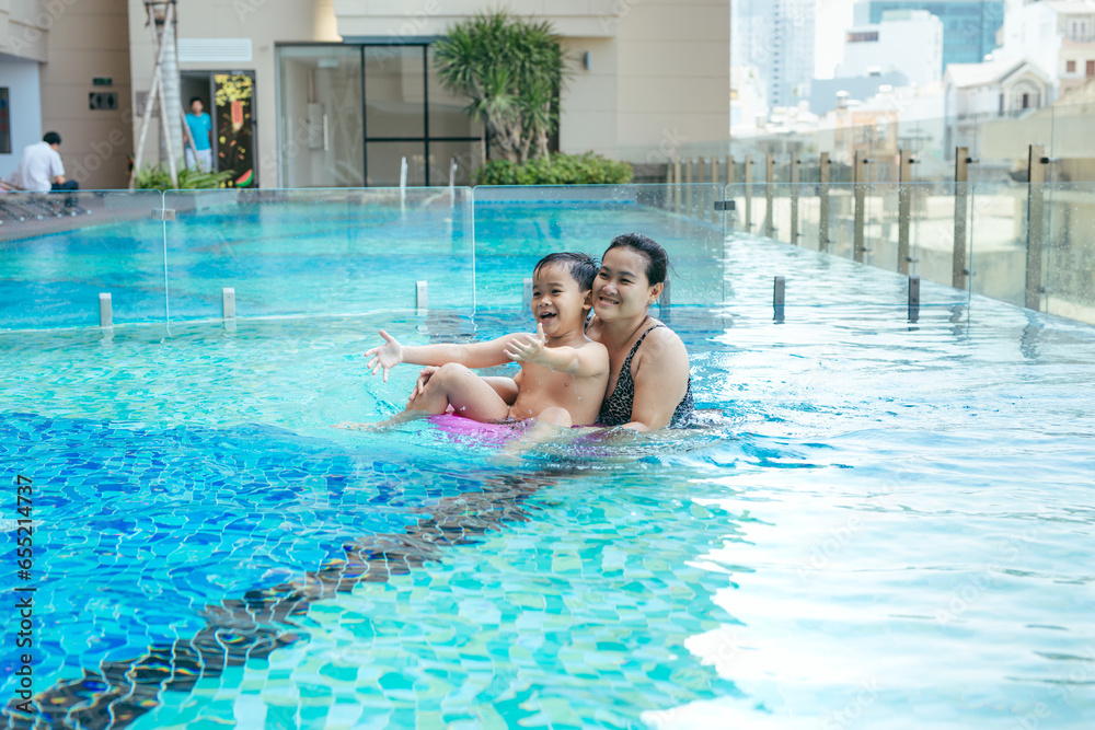 Mother and son having a great time in the pool. Mother and son having a great time in the pool.