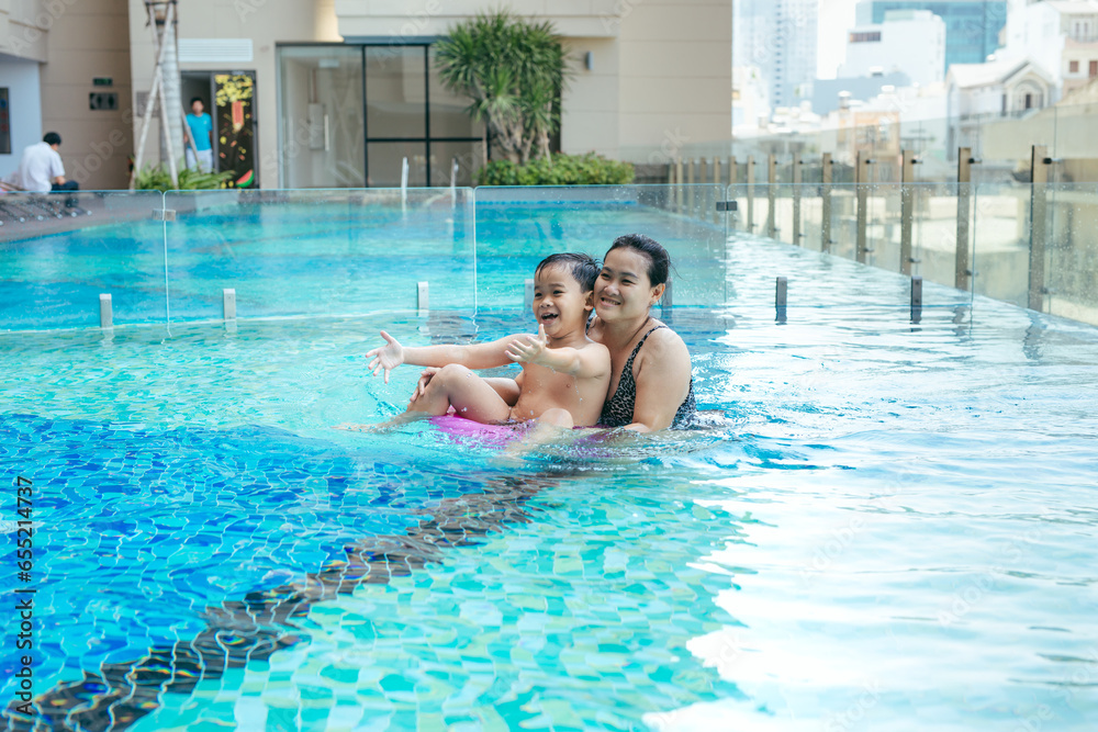 Mother and son having a great time in the pool.