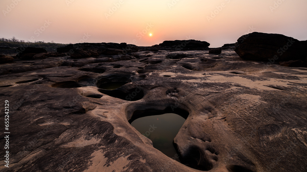 landscape of rock or sandstones and water pond the sunset background, at  Sam Phan Bok, Ubon Ratchathani