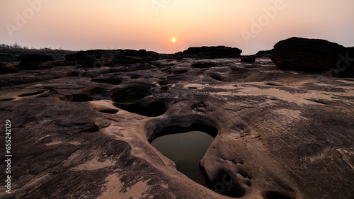 landscape of rock or sandstones and water pond the sunset background, at Sam Phan Bok, Ubon Ratchathani