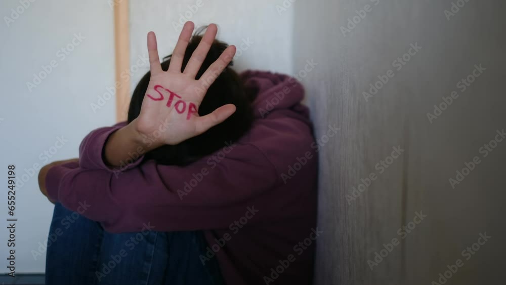A powerful image depicting the consequences of domestic violence and abuse, showing a woman with visible grazes and beatings on her face, accompanied by the stark word 