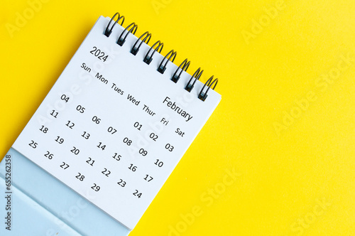 February 2024 table calendar on yellow cover background with customizable space for text.