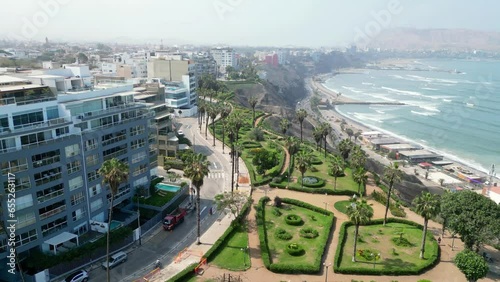 Aerial view of the region between Barranco and Miraflores in September 2023. Avenue with cars, people walking and gardens in an upscale region of Lima, Peru.