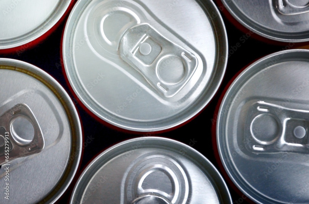 Many cans of soda soft drink or energy drink containers. A lot of recycled cans made from