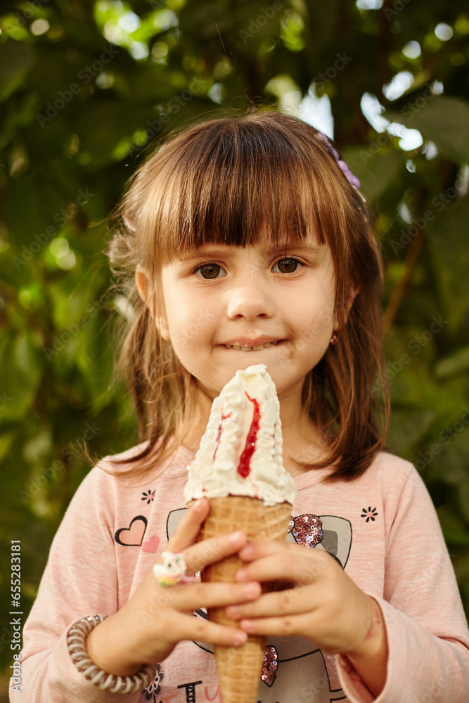 Cute Little girl eating delicious ice-cream in the city park on a summer sunny day. Cute Little girl eating delicious ice-cream in the city park on a summer sunny day.