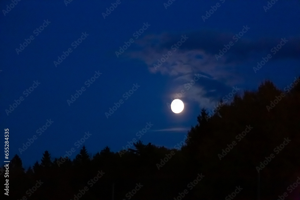 Full moon with a blue sky