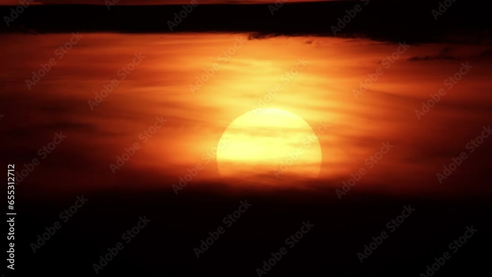 African sunset time lapse with big sun disk and backlit clouds. Cinematic and epic hot summer sunset timelapse with big red and orange sun circle. African sunset time lapse with big sun disk and backlit clouds. Cinematic and epic hot summer sunset timelapse with big red and orange sun circle.