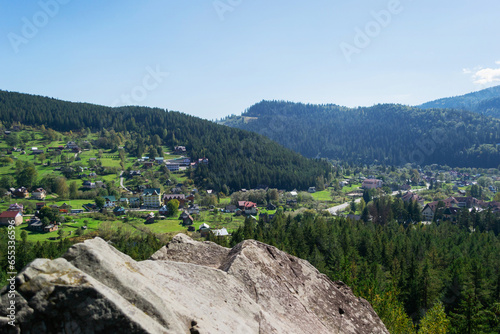 Aerial of a Ukrainian village in the Carpathians during sunny afternoon (ID: 655336596)