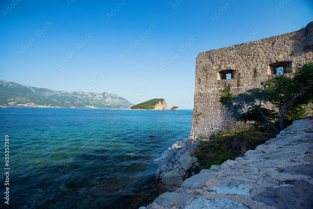 View to old defensive walls of Budva and Sveti Nikola island in the background