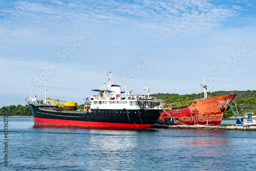 a ship with an excavator standing in the port