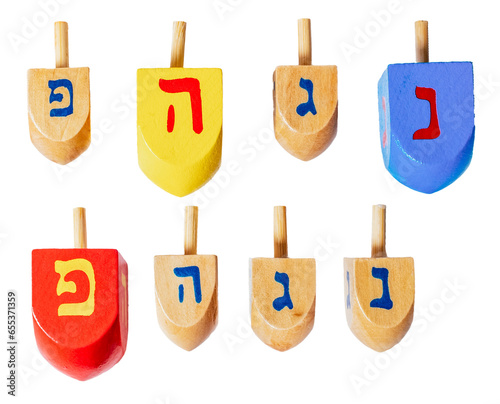 Wooden dreidels for Hanukkah isolated on white or transparent background. photo