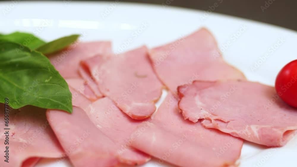 Buffet table in a hotel or restaurant on vacation. Sliced ​​sausage and ham in a white plate. The concept of a holiday, tasty and nutritious food.