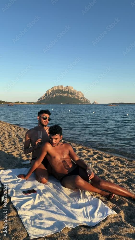gay couple on the beach at sunset in tavolara italy gay couple on the beach at sunset in tavolara italy