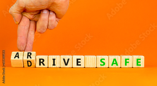 Drive and arrive safe symbol. Concept words Drive safe Arrive safe on wooden blocks. Beautiful orange table orange background. Businessman hand. Business drive and arrive safe concept. Copy space.