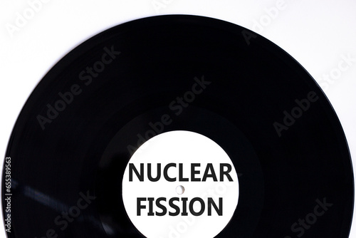 Nuclear fission symbol. Concept words Nuclear fission on beautiful black vinyl disk. Beautiful white table white background. Business science nuclear fission concept. Copy space.