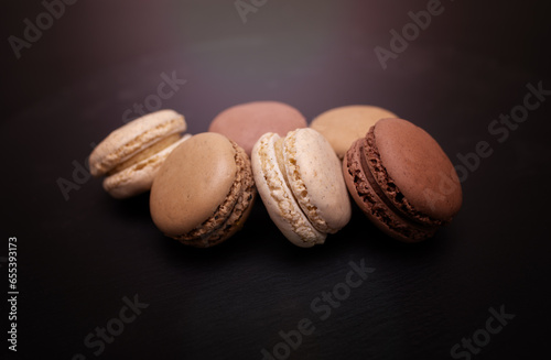 Macaroons on a black background. Selective focus.