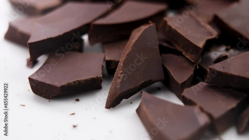 Chopped crushed dark chocolate chunks close up. Rotation