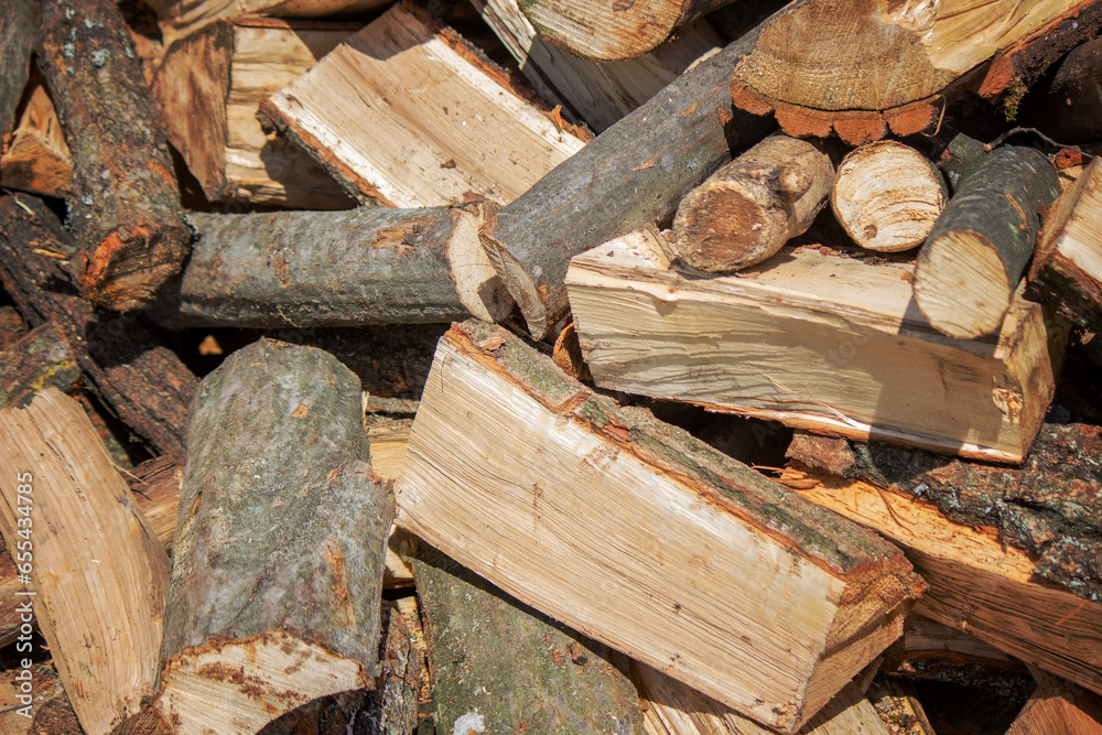 Wall of firewood, background of dry chopped firewood. Wooden background. Natural texture. Wall of firewood, background of dry chopped firewood. Wooden background. Natural texture.