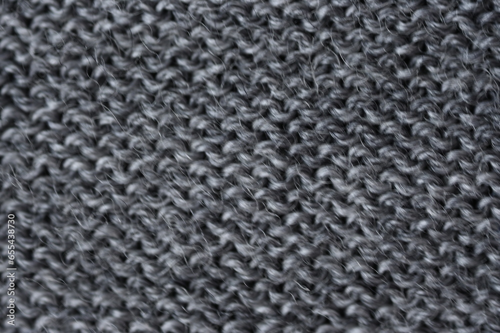 macro texture of gray woolen sweater, close up of a piece of knitted fabric, winter woolen piece of crocheted fabric as a background macro texture of gray woolen sweater, close up of a piece of knitted fabric, winter woolen piece of crocheted fabric as a background