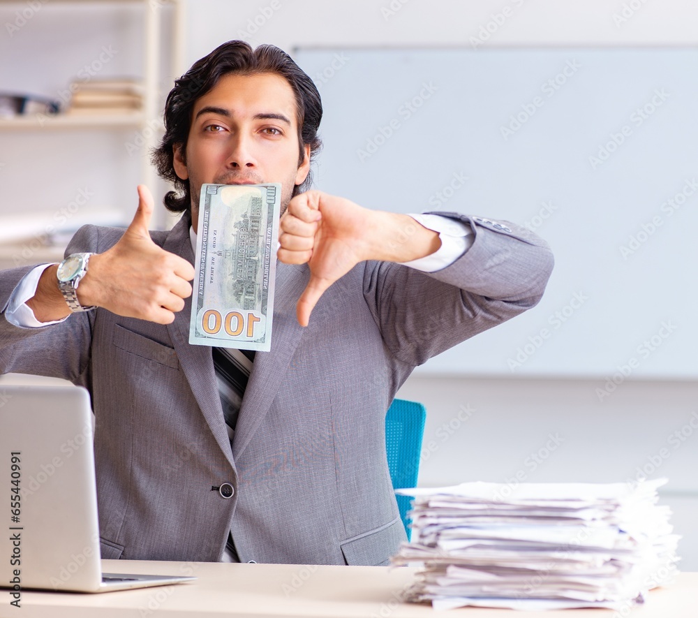 Young handsome businessman employee sitting in the office Young handsome businessman employee sitting in the office