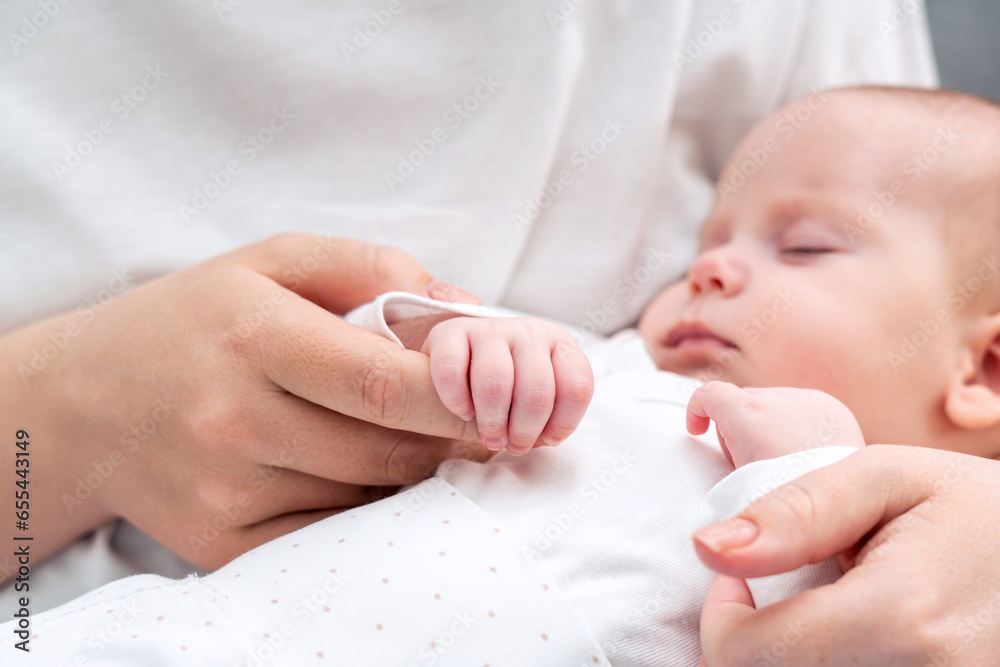 Tiny fingers of newborn find comfort in mother's touch. Concept of the profound love and attachment Tiny fingers of newborn find comfort in mother's touch. Concept of the profound love and attachment