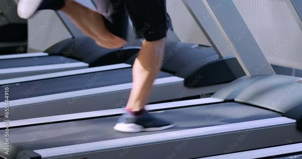 unrecognizable young man training at gym, guy runs on treadmill, confident bodybuilder working his body in sport club, bodybuilding concept, legs close up unrecognizable young man training at gym, guy runs on treadmill, confident bodybuilder working his body in sport club, bodybuilding concept, legs close up