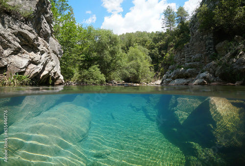 Rocky river with clear water, split level view over and under water surface, Spain, Catalonia, Alt Emporda photo