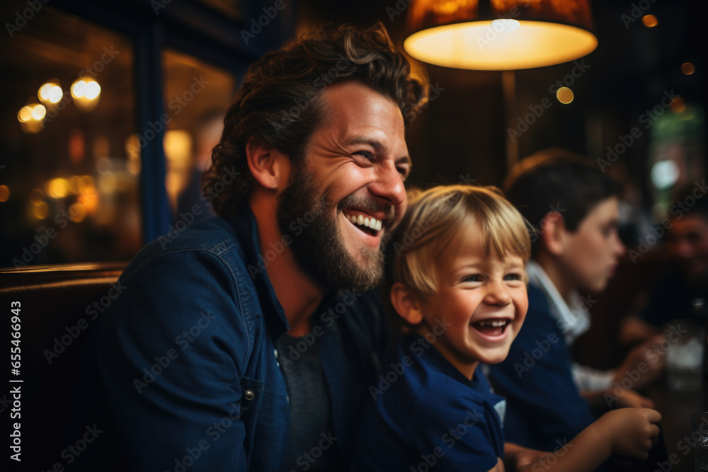 Man sitting next to little boy at table. This image can be used to depict father and son bonding over meal or working together on project Man sitting next to little boy at table. This image can be used to depict father and son bonding over meal or working together on project