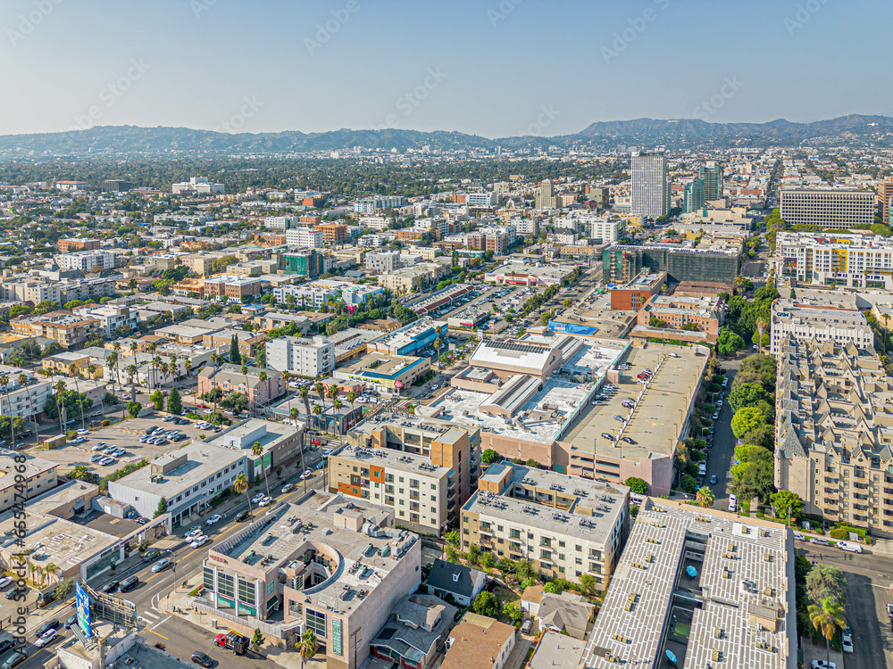 Los Angeles, California – September 19, 2023: aerial drone view toward LA Koreatown with Western Ave including apartments, condominiums, houses, buildings, Korea Plaza market at sunny day 