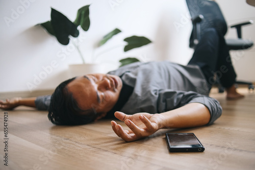Photos Businessman lying unconscious on the office floor
