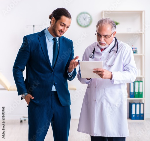 Male doctor and businessman discussing medical project photo