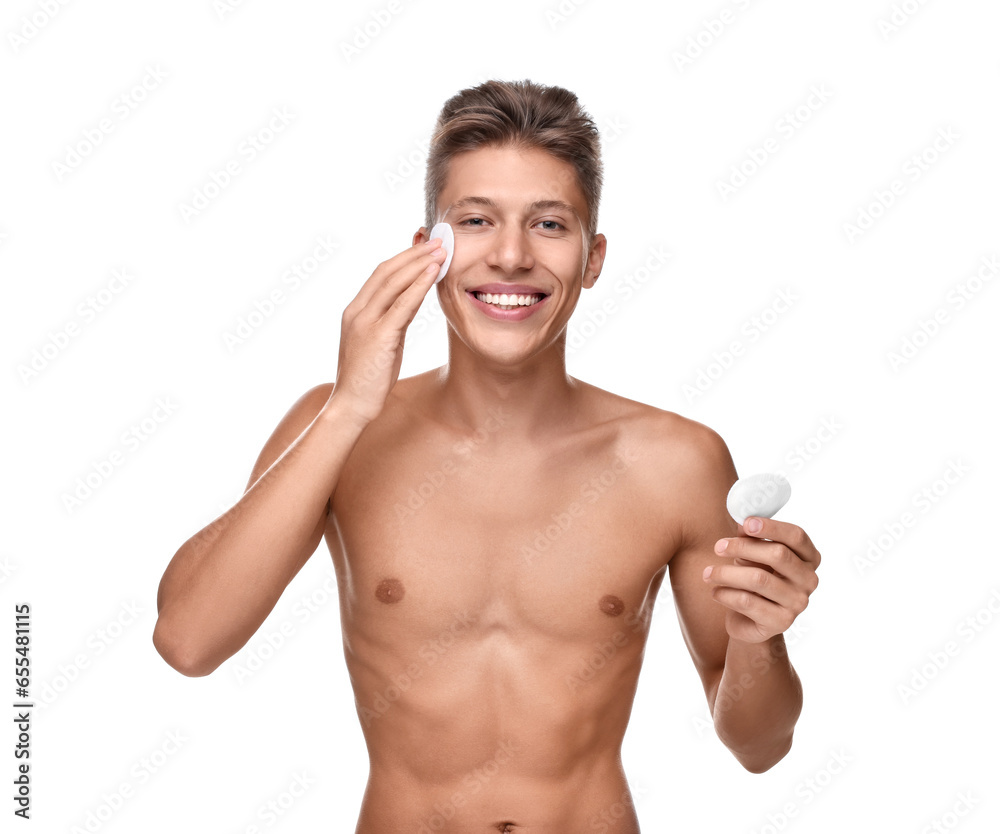 Fototapeta premium Handsome man cleaning face with cotton pad on white background