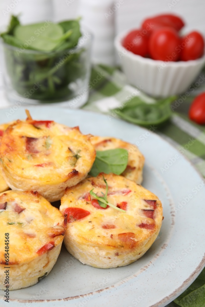 Delicious egg muffins with cheese and bacon on table, closeup. Space for text Delicious egg muffins with cheese and bacon on table, closeup. Space for text