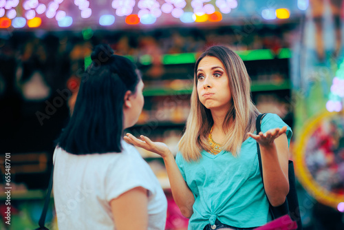 Women Arguing over a Misunderstanding on the Street. Girl apologizing for wrongdoing to her best friend 
 photo