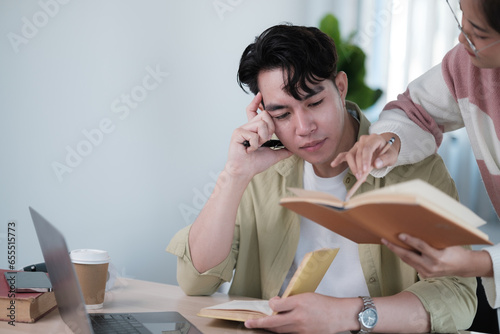 A friendly and kind Asian female friend is helping her friend with math lessons, tutoring, and preparing for the exam with her friend at home. Education concept