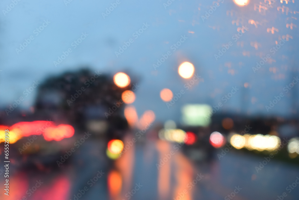 traffic jam on the road in night with rain, defocused background - obrazy, fototapety, plakaty 