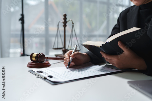 Consultation of businesswoman and lawyer or legal consultant having team meeting with client, law, justice, law book, good service cooperation concept. photo