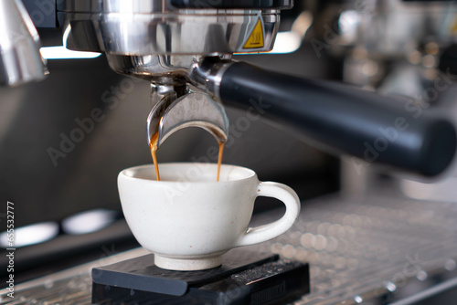 pull espresso shot with portafilter on a professional coffee machine