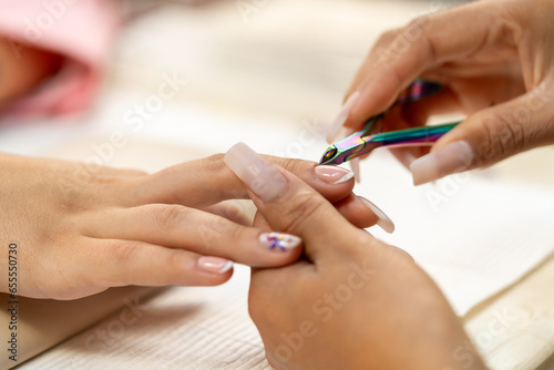 Close-up of the hands of a woman receiving a manicure