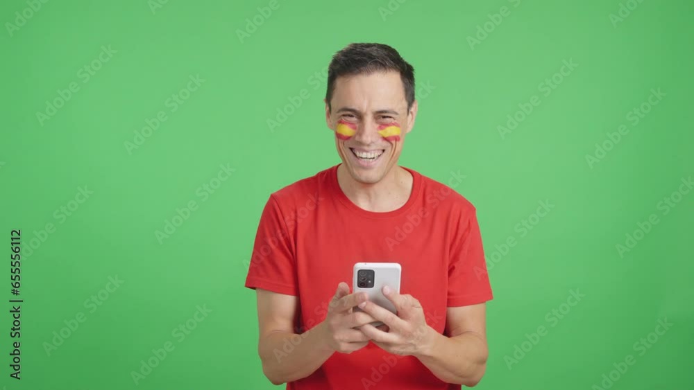 Spanish man looking at his mobile smiling and showing it. Spanish man looking at his mobile smiling and showing it.