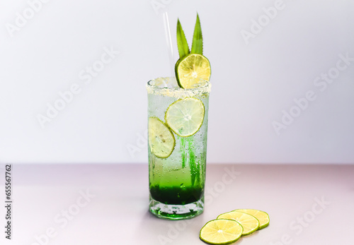 Panda leaves lemonade with desiccated coconut and green syrup on light gray background with copy space
