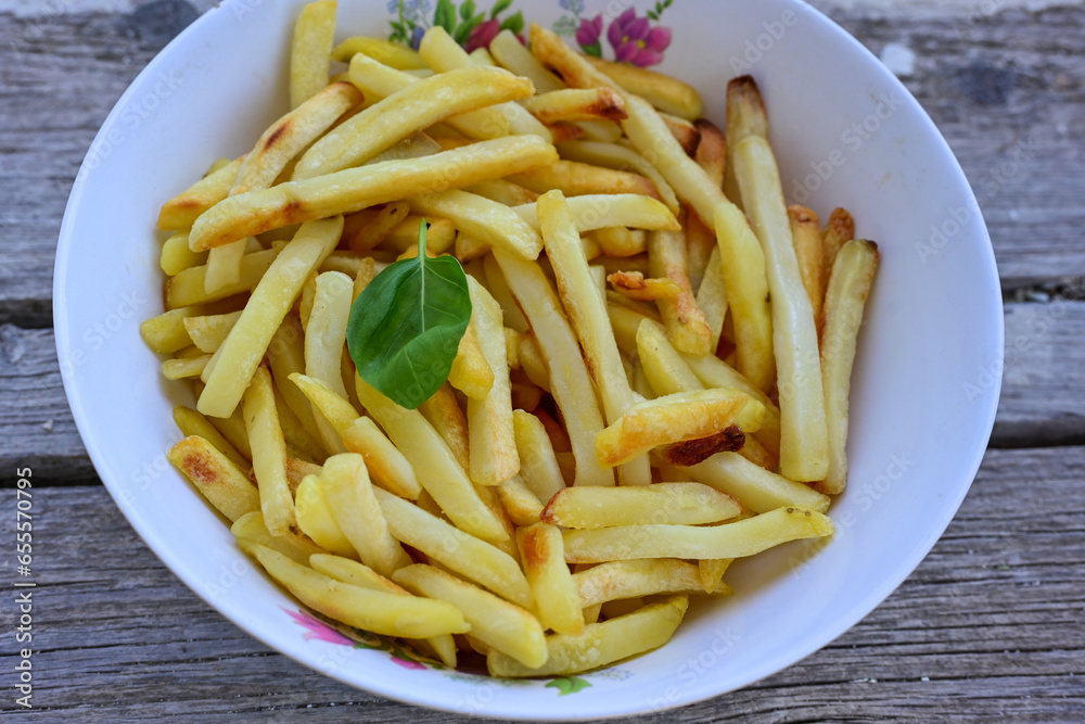 Home made organic Fresh fried French fries on wooden background Home made organic Fresh fried French fries on wooden background