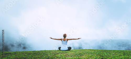 Asian women relax in the holiday. Play if yoga, natural forests, mountains and mist.