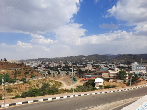 Beautiful daytime sky view of Al Bahah city in Saudi Arabia. City buildings, hills and clouds are visible in the background. photo