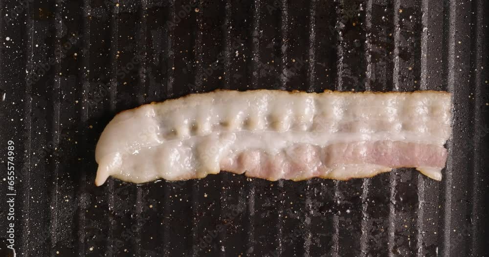 Frying halal beef bacon in pan top view close up. Smoked bacon rasher