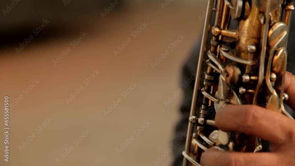 Close up handheld shot of musician playing wind instrument during event