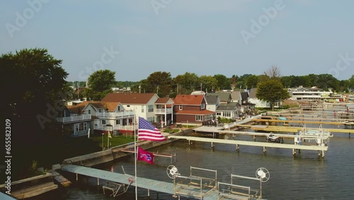 Drone shot of the beach houses and docks and boats and flags at Sodus point New York vacation spot at the tip of land on the banks of Lake Ontario. photo