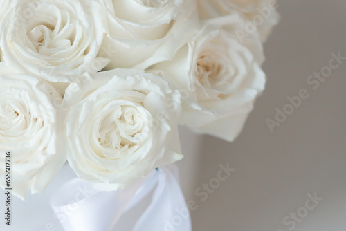 White roses bouquet on white background with soft focus.