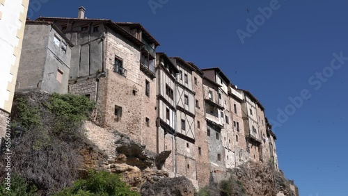 Housemartin birds nesting in the walls of old building and flying around 