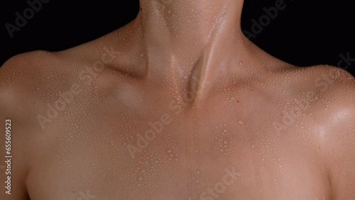 Closeup studio shot of beautiful woman model body part, open chest neck and shoulders area softnatural skin view.